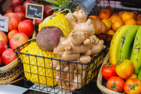 Ginger,melon,apple, Beetroot, tomatoes and mango on the wood and black basket at the market in Thailand. Select focus.の写真素材