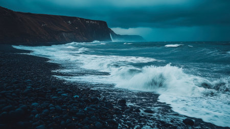 A stunning view of crashing ocean waves against rugged cliffs under a dramatic sky. This moody coastal landscape captures the raw beauty of nature.の素材