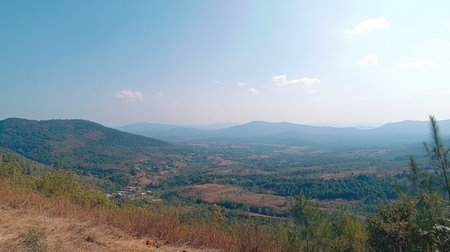 Stunning view of a serene mountain landscape featuring rolling hills and lush greenery under a bright blue sky, perfect for outdoor enthusiasts.の素材