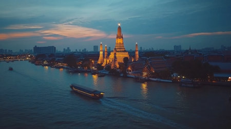 A stunning night view of a temple along the river, illuminated with vibrant lights. The serene waters reflect the architecture, offering a perfect backdrop for travel and exploration.の素材