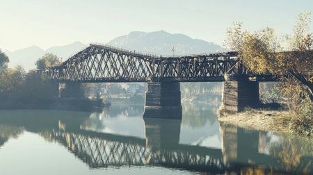 A stunning view of a rustic wooden bridge spanning a calm river, surrounded by vibrant autumn foliage and mountains, capturing a tranquil outdoor landscape.の素材