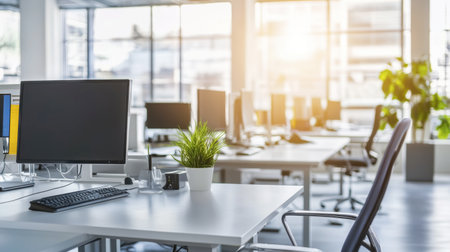 A modern office space featuring clean desks, computers, and a touch of greenery. This bright and open environment is designed for productivity and creativity.の素材