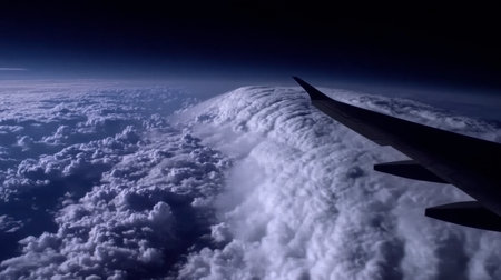 A breathtaking view from an airplane wing above fluffy clouds, capturing the vastness of the sky and the beauty of nature during flight, perfect for travel themes.の素材