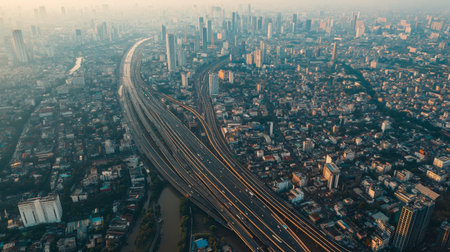 Aerial view of Bangkok's bustling cityscape, with skyscrapers, highways, and dense neighborhoods.の素材