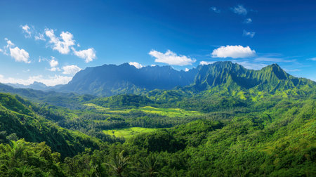 A panoramic view of Ackmon National Park lush green valleys surrounded by towering mountains under a clear blue sky.の素材