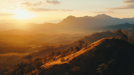 A sunset view over the mountains in Khao Yai National Park, with golden light illuminating the landscape.の素材