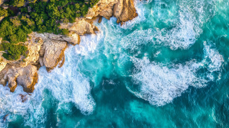 Discover a stunning aerial view of turquoise ocean waves crashing against rocky shorelines, showcasing the beauty of nature's vibrant colors and textures.の素材