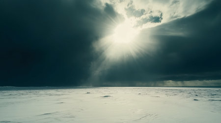 A stunning view of a snowy landscape under dramatic skies, featuring bright sunlight breaking through dark clouds, creating a captivating atmosphere.の素材