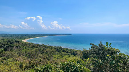 A scenic viewpoint on Koh Samet, overlooking the vast ocean with lush green tropical foliage surrounding the beach.の素材