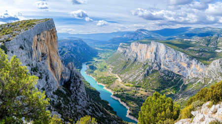 An adventurous rock climber scaling the cliffs of the Gorges du Verdon, with the valley stretching out below.の素材