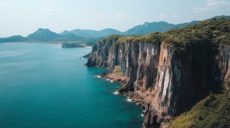 Experience the breathtaking beauty of rugged coastal cliffs meeting clear blue waters in this serene aerial view, perfect for travel and nature enthusiasts.の素材