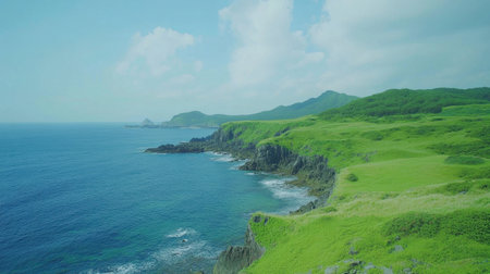 This stunning coastal landscape features lush green hills, rocky shorelines, and clear turquoise waters, creating a serene atmosphere perfect for nature lovers and travelers.の素材