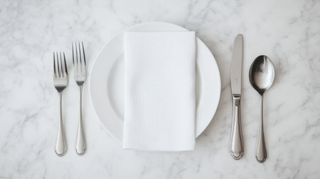 Discover a refined table setting featuring a crisp white napkin on a round plate, elegantly surrounded by polished cutlery, perfect for dining occasions.の素材
