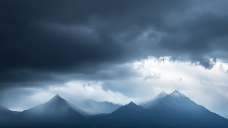 A breathtaking mountain landscape showcasing dark storm clouds with rays of sunlight breaking through, creating a dramatic yet serene atmosphere in nature's pristine wilderness.の素材