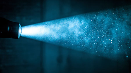 A mesmerizing beam of light pierces through darkness, illuminating floating dust particles. This visually striking image evokes a sense of wonder and intrigue.の素材