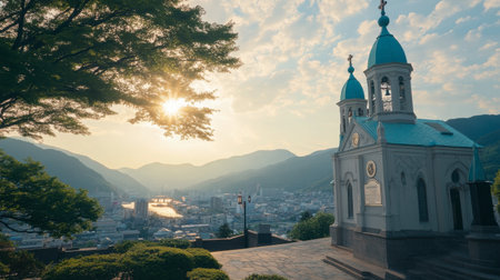 A breathtaking view of a church atop a mountain at sunset, overlooking a sparkling city below. This serene scene captures the essence of tranquil beauty in nature.の素材