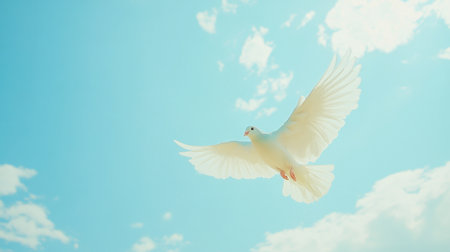 A stunning white dove soars gracefully through a vibrant blue sky adorned with fluffy clouds, symbolizing peace and freedom in nature's beauty.の素材