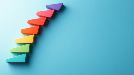 Bright and colorful geometric shapes create an ascending line on a blue background, representing growth and progress in a visually appealing way. Ideal for various concepts.の素材