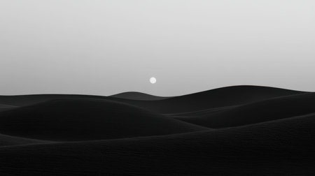 A serene black and white image of a desert landscape at dusk, featuring gentle dunes and a soft sun setting on the horizon, evoking tranquility and calmness.の素材