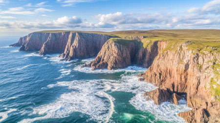 Breathtaking view of rugged coastal cliffs meeting a vibrant ocean. The sunlight glistens on the waves, creating a serene natural landscape ideal for travel enthusiasts.の素材