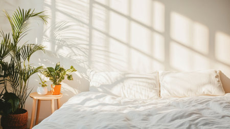 A serene bedroom scene featuring a cozy bed bathed in soft morning light, complemented by greenery. Perfect for conveying calm and relaxation in home decor.の素材