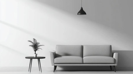 A modern living room featuring a sleek grey sofa, stylish table, and minimal decor highlighting light and shadows for a cozy atmosphere.の素材