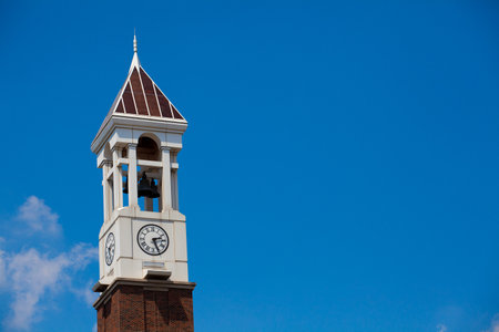 Clock tower with bells on clear blue skyの写真素材
