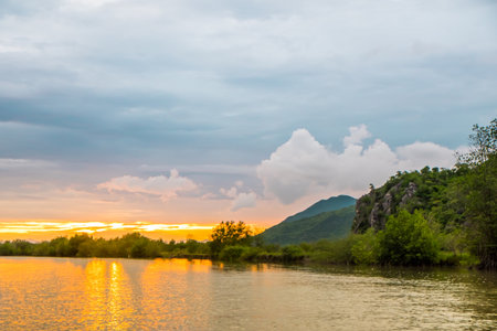 Blurred sea and mountain sunset for background.の写真素材