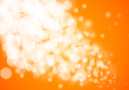 Orange bokeh glitter defocused lights abstract backgroundの写真素材