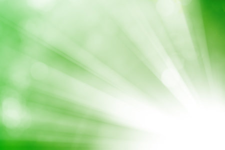 Green glitter sparkle defocused rays lights bokeh abstract background.の写真素材