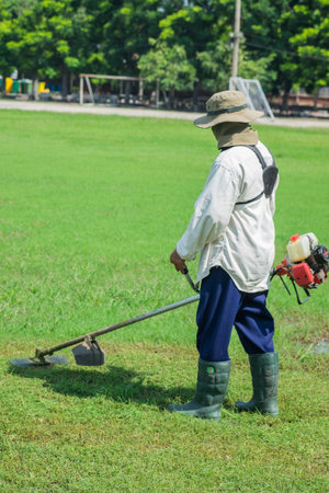 Man cutting glass work in garden.の写真素材