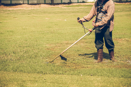 Man cutting glass work in garden.vintage or retro tone.の写真素材