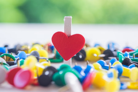 Heart of paper clip about love relationship with many pins for background.の写真素材