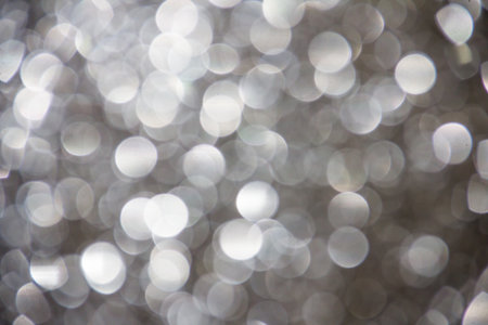 Grey glitter sparkle defocused rays lights bokeh beautiful abstract background.の写真素材