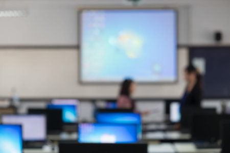 Defocused student study computer classroom for background.