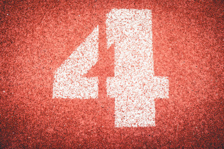 Numbers four on rubber running track standard red color.