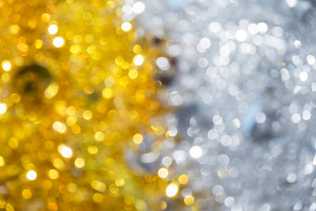 Gold half silver glitter sparkle defocused rays lights bokeh abstract chistmas background.の写真素材