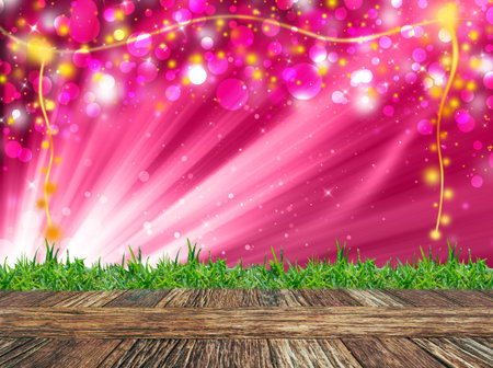 Empty wooden deck table and grass with pink glitter sparkle defocused rays lights bokeh abstract chistmas background. Product display template .の写真素材