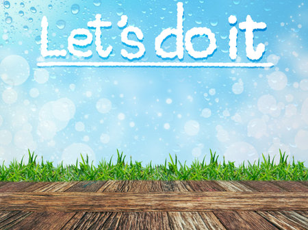Empty wooden table and grass with word "Let's do it" cloud message on water drops bokeh background. Product display template.の写真素材