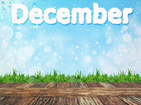 Empty wooden table and grass with word "december" cloud message on water drops bokeh background. Product display template.の写真素材