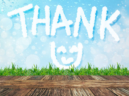 Empty wooden table and grass with word "Thnak" cloud message on water drops bokeh background. Product display template.の写真素材