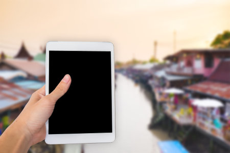 Hands are holding touch screen White Tablet Computer with white background/isolated.