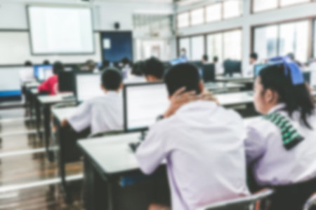 Defocused student study computer classroom for background.VIntage or retro tone.の写真素材