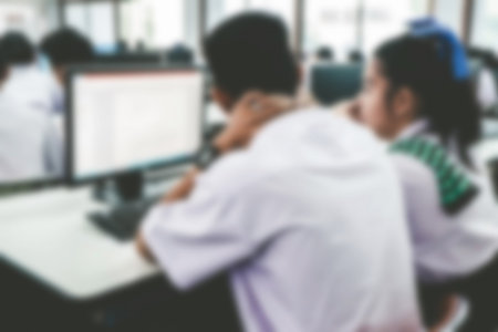 Defocused student study computer classroom for background.VIntage or retro tone.の写真素材
