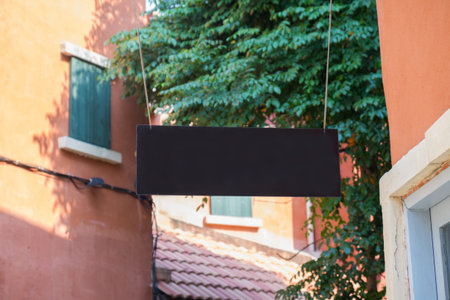 Blank sign hanging with vintage building style background.の写真素材