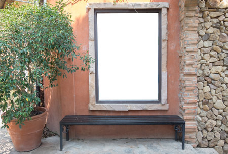 Vertical blank billboard with brick and bench.の写真素材