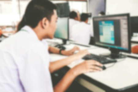 Defocused student study computer classroom for background.の写真素材