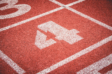 Numbers four on rubber running track standard red color.
