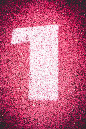 Numbers one on rubber running track standard red color.Vintage or retro tone.の写真素材