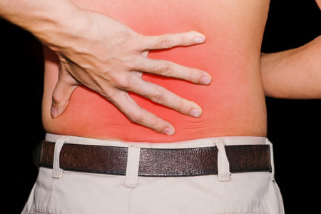 Close-up a young man suffering from back pain.の写真素材